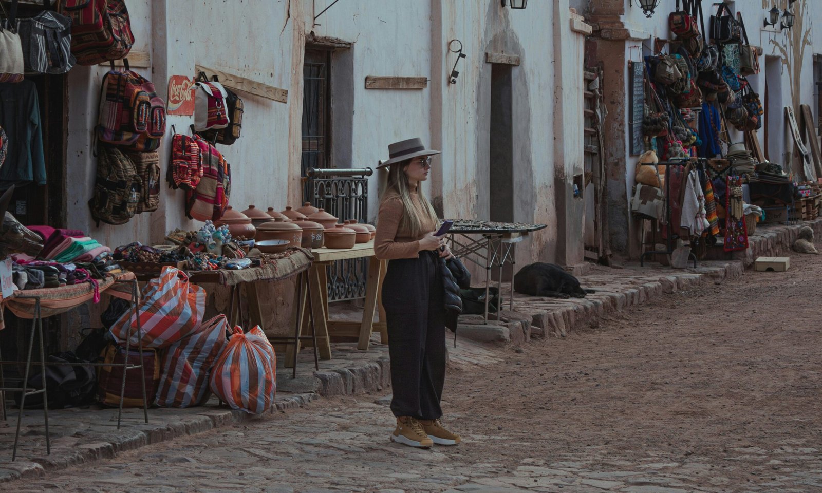 A man is standing in front of a market